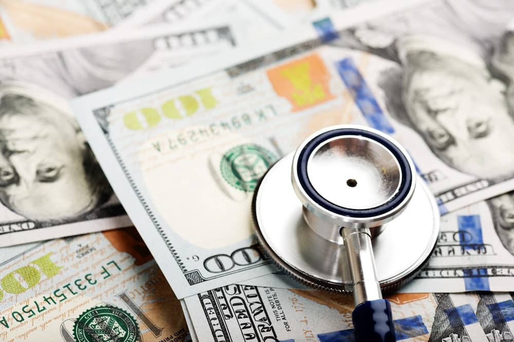 Image is of a stethoscope placed on currency representing healthcare costs and financial losses after an accident, concept of a personal injury lawyer.